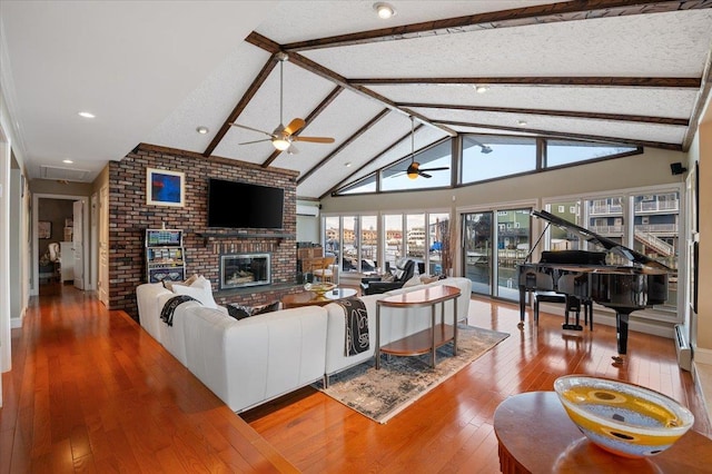 living room featuring a fireplace, a baseboard radiator, high vaulted ceiling, beamed ceiling, and hardwood / wood-style floors