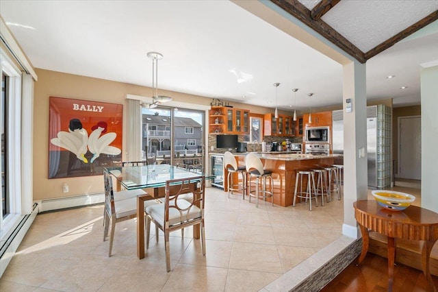 dining room featuring light tile patterned floors and baseboards