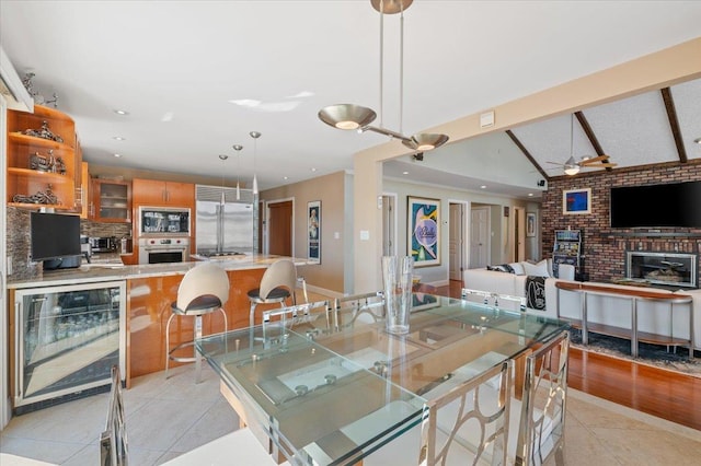 dining space featuring wine cooler, vaulted ceiling with beams, light tile patterned floors, recessed lighting, and ceiling fan