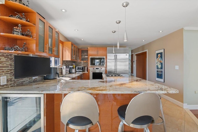 kitchen featuring built in appliances, wine cooler, a sink, backsplash, and glass insert cabinets