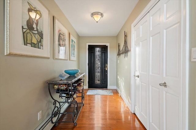 foyer featuring wood finished floors and baseboards