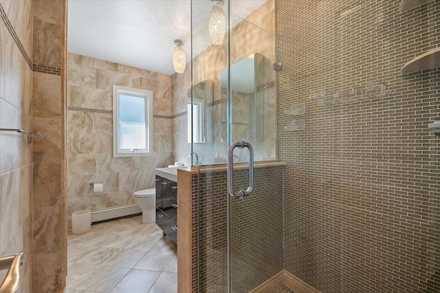 full bathroom featuring toilet, tile patterned flooring, vanity, a shower stall, and a baseboard heating unit