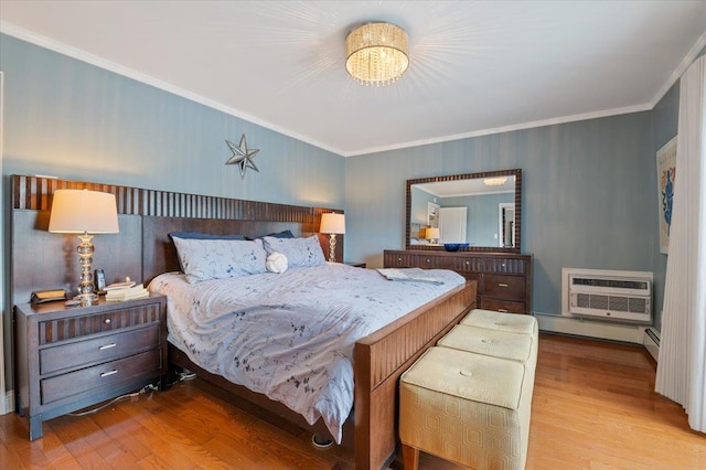 bedroom featuring a notable chandelier, a baseboard heating unit, wood finished floors, a wall mounted AC, and crown molding