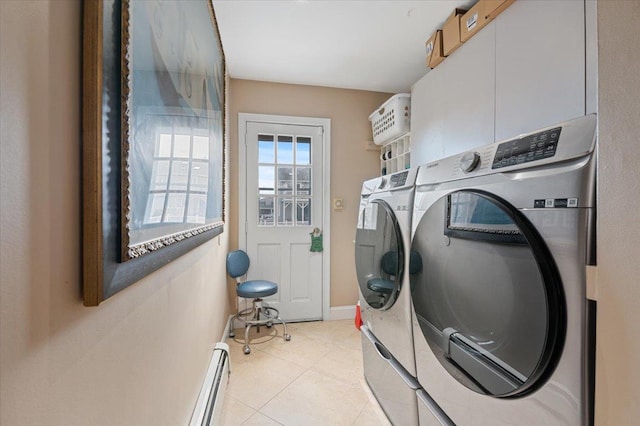 washroom featuring light tile patterned floors, washing machine and dryer, laundry area, baseboards, and baseboard heating