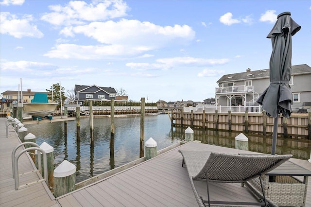 dock area featuring a water view and a residential view