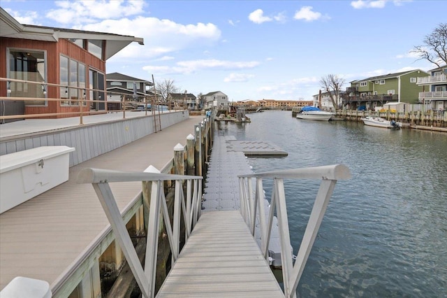 dock area featuring a residential view and a water view