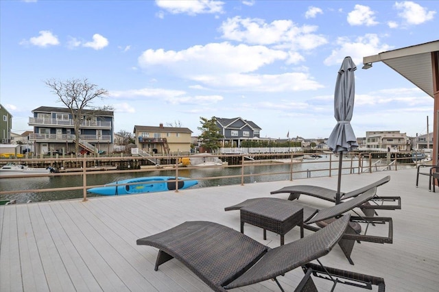 view of dock featuring a water view and a hot tub