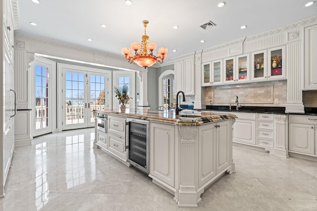28 Whitney Cir, Glen Cove, NY 11542 - kitchen with beverage cooler, visible vents, a chandelier, and a sink