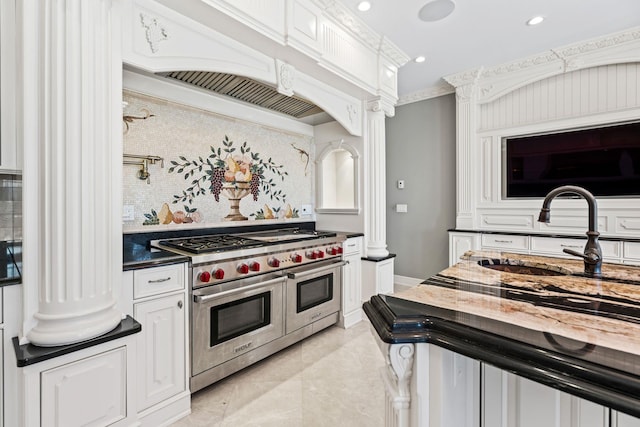 28 Whitney Cir, Glen Cove, NY 11542 - kitchen with tasteful backsplash, crown molding, range with two ovens, ornate columns, and a sink