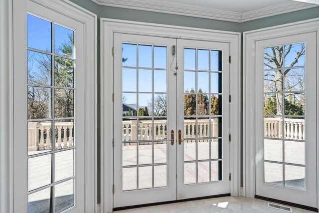 28 Whitney Cir, Glen Cove, NY 11542 - doorway featuring visible vents, ornamental molding, and french doors