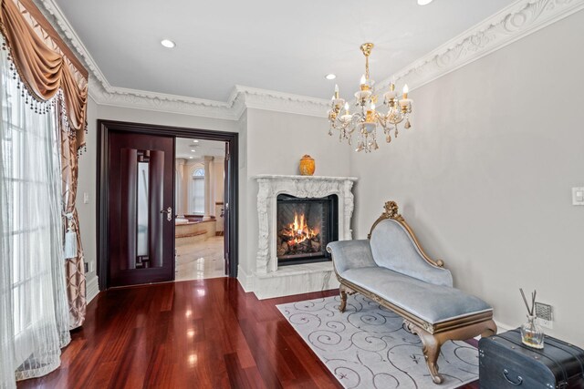 28 Whitney Cir, Glen Cove, NY 11542 - sitting room featuring a high end fireplace, a chandelier, ornamental molding, recessed lighting, and wood finished floors