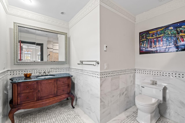 28 Whitney Cir, Glen Cove, NY 11542 - half bath featuring vanity, a wainscoted wall, crown molding, tile walls, and toilet