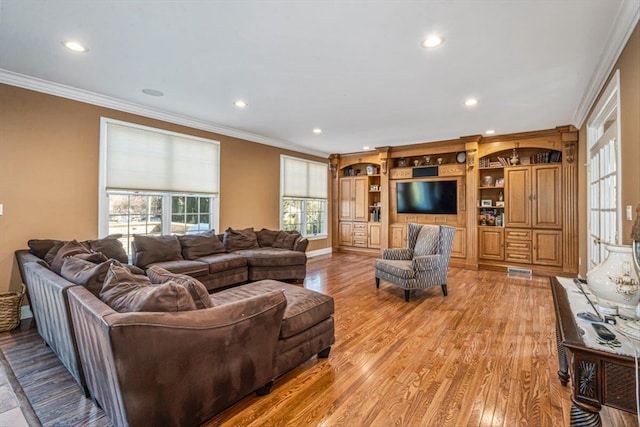 living room featuring recessed lighting, light wood-style floors, visible vents, and ornamental molding