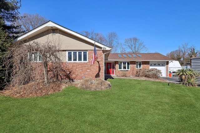 view of front of property with brick siding, an attached garage, and a front yard