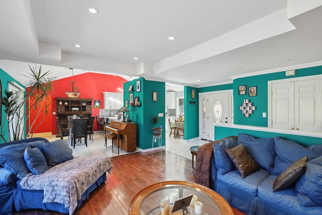 living room with crown molding, baseboards, wood finished floors, and recessed lighting