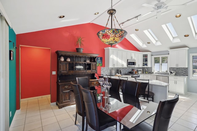 dining area with light tile patterned floors, ceiling fan, and lofted ceiling