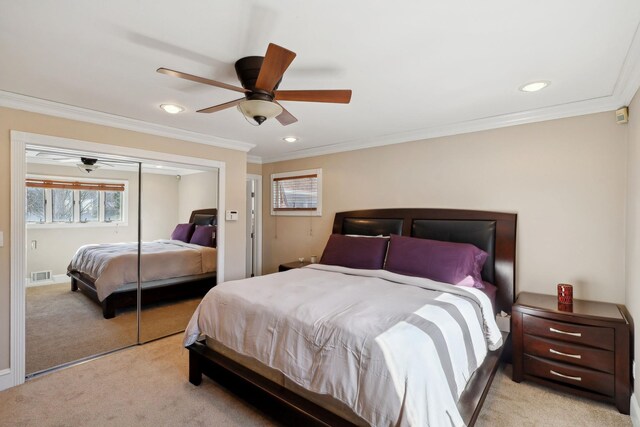 bedroom featuring ornamental molding, a closet, visible vents, and light colored carpet