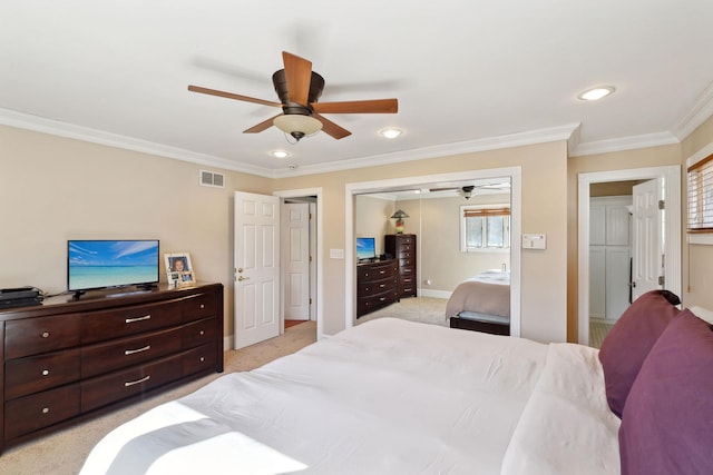 bedroom with light carpet, visible vents, a ceiling fan, crown molding, and a closet