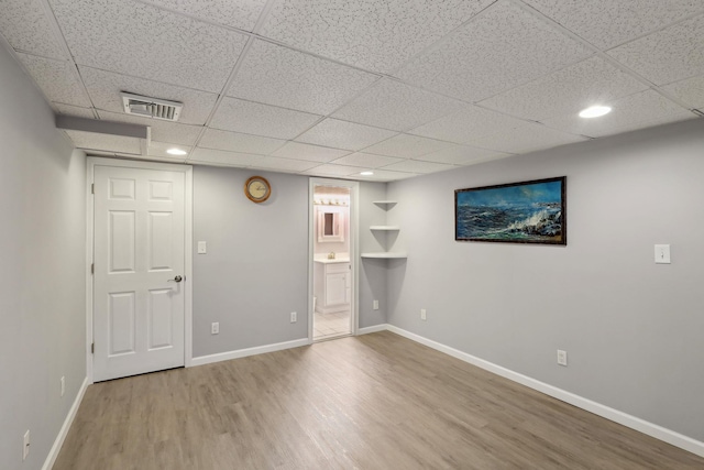 interior space with recessed lighting, a paneled ceiling, visible vents, wood finished floors, and baseboards