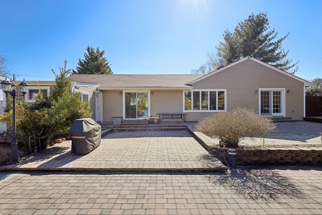 rear view of property with entry steps and a patio area