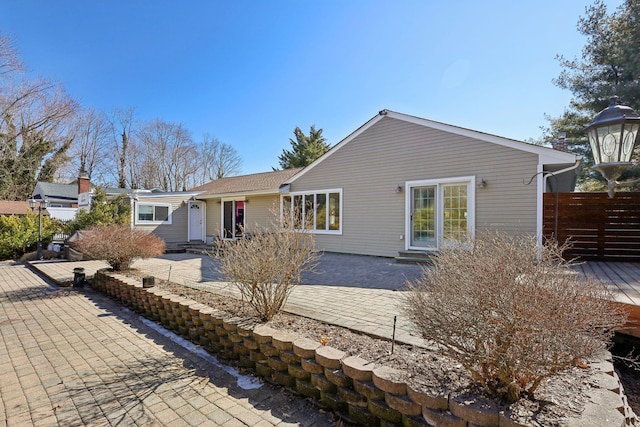 back of property featuring entry steps, a patio area, and fence