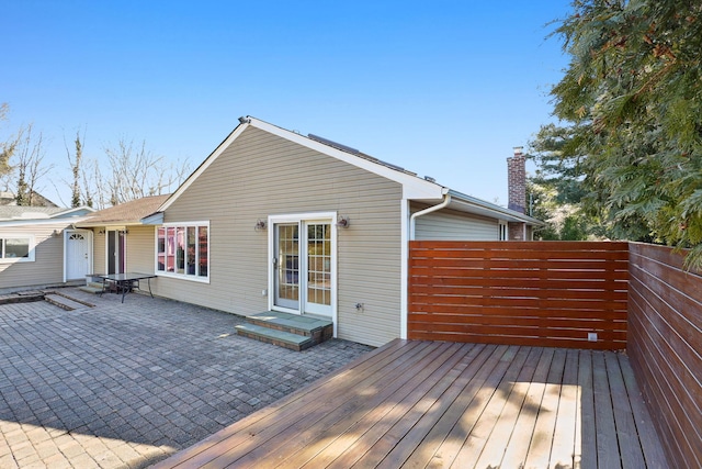 wooden terrace featuring a patio area and fence