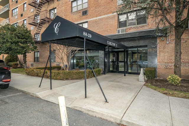 entrance to property featuring brick siding