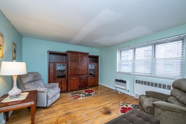 living room with radiator, light wood-style flooring, heating unit, and a wall mounted AC