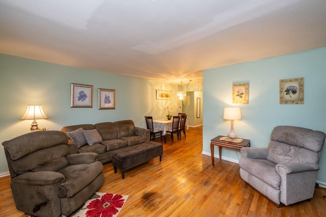 living room featuring baseboards and light wood-style floors