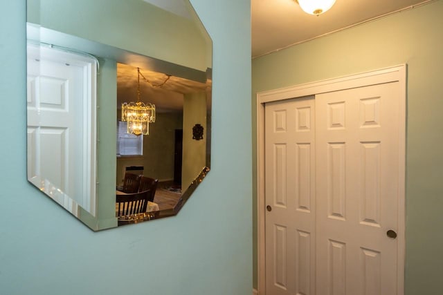 hall featuring an inviting chandelier