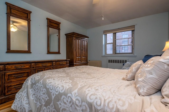 bedroom with ceiling fan and radiator heating unit