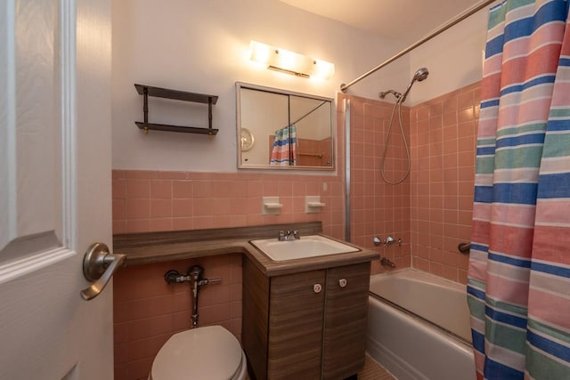 full bath featuring toilet, vanity, tile walls, and shower / tub combo with curtain