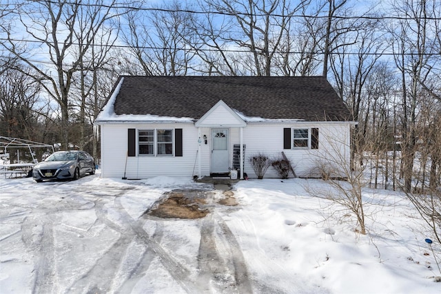 view of front of property featuring entry steps and roof with shingles