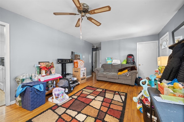 recreation room featuring ceiling fan, wood finished floors, and baseboards