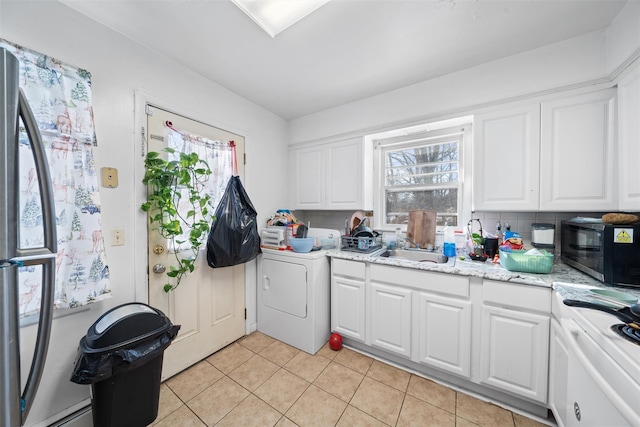 laundry room with light tile patterned floors, laundry area, a sink, and washer / dryer