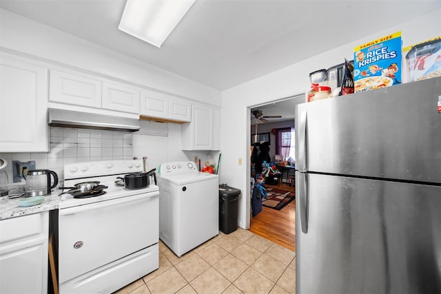 kitchen featuring washer / dryer, light tile patterned floors, freestanding refrigerator, white electric range, and under cabinet range hood