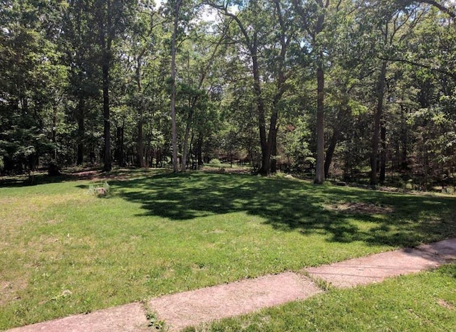 view of yard with a wooded view