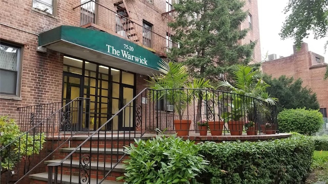 property entrance featuring brick siding