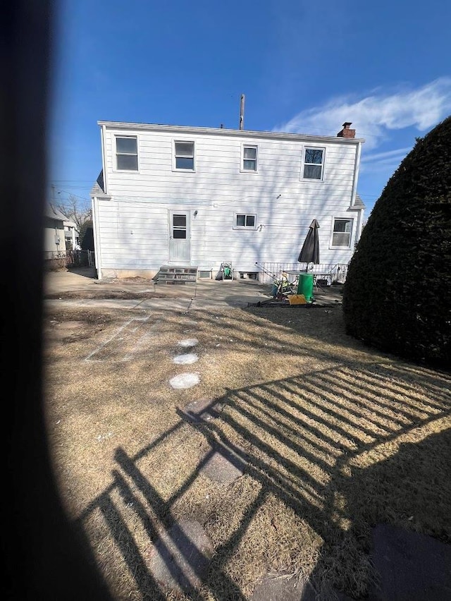 rear view of property with entry steps