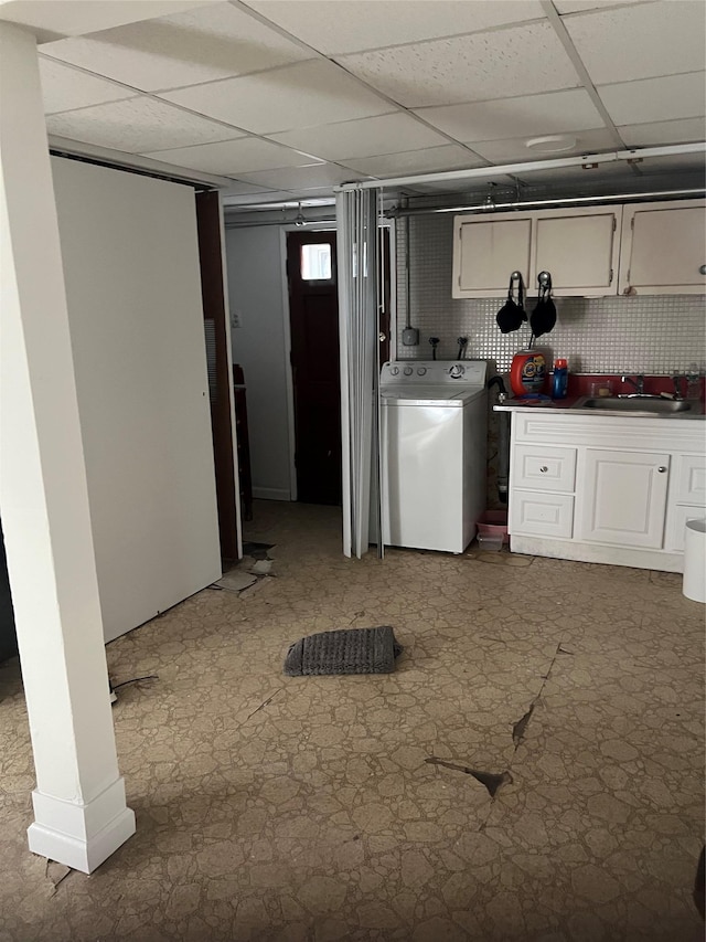 laundry room with laundry area, a sink, washer / dryer, and tile patterned floors