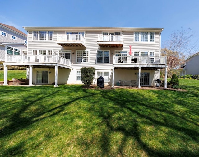 back of property with a lawn and a wooden deck