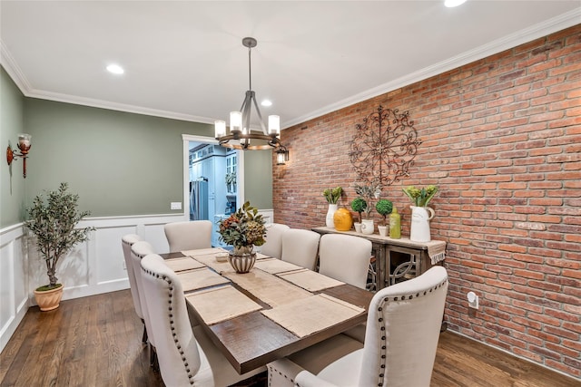 dining area with a wainscoted wall, brick wall, dark wood finished floors, and crown molding