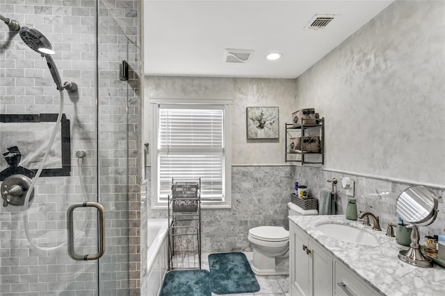 bathroom featuring toilet, a stall shower, vanity, and visible vents