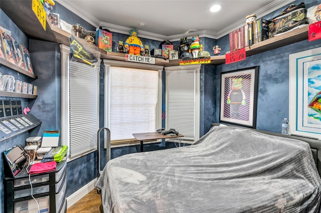 bedroom featuring ornamental molding, wood finished floors, and baseboards