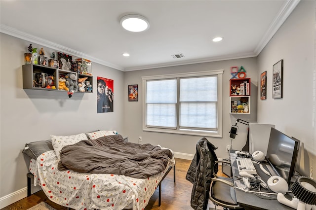 bedroom featuring ornamental molding, wood finished floors, and visible vents