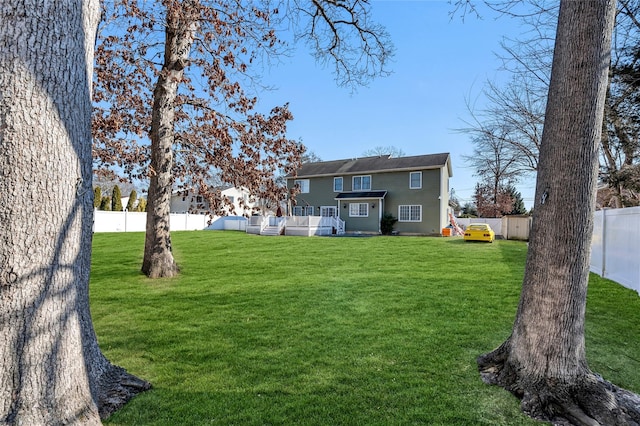 exterior space featuring a fenced backyard and a yard