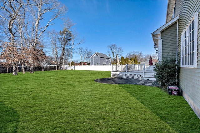 view of yard with a deck and fence