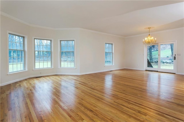 unfurnished room featuring light wood-style floors, baseboards, and an inviting chandelier