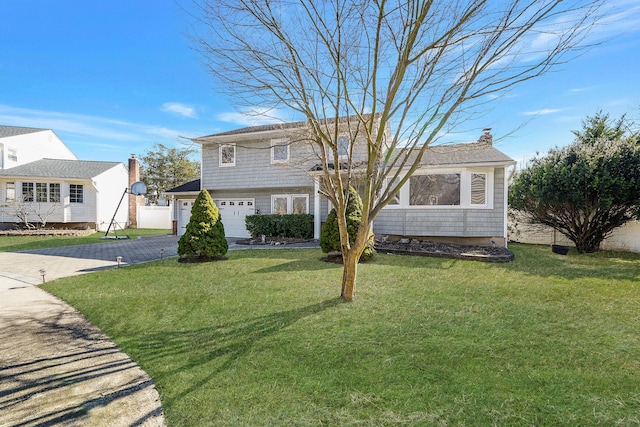 tri-level home featuring aphalt driveway, a chimney, fence, a garage, and a front lawn