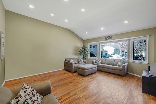 living area featuring lofted ceiling, recessed lighting, light wood-style flooring, and baseboards